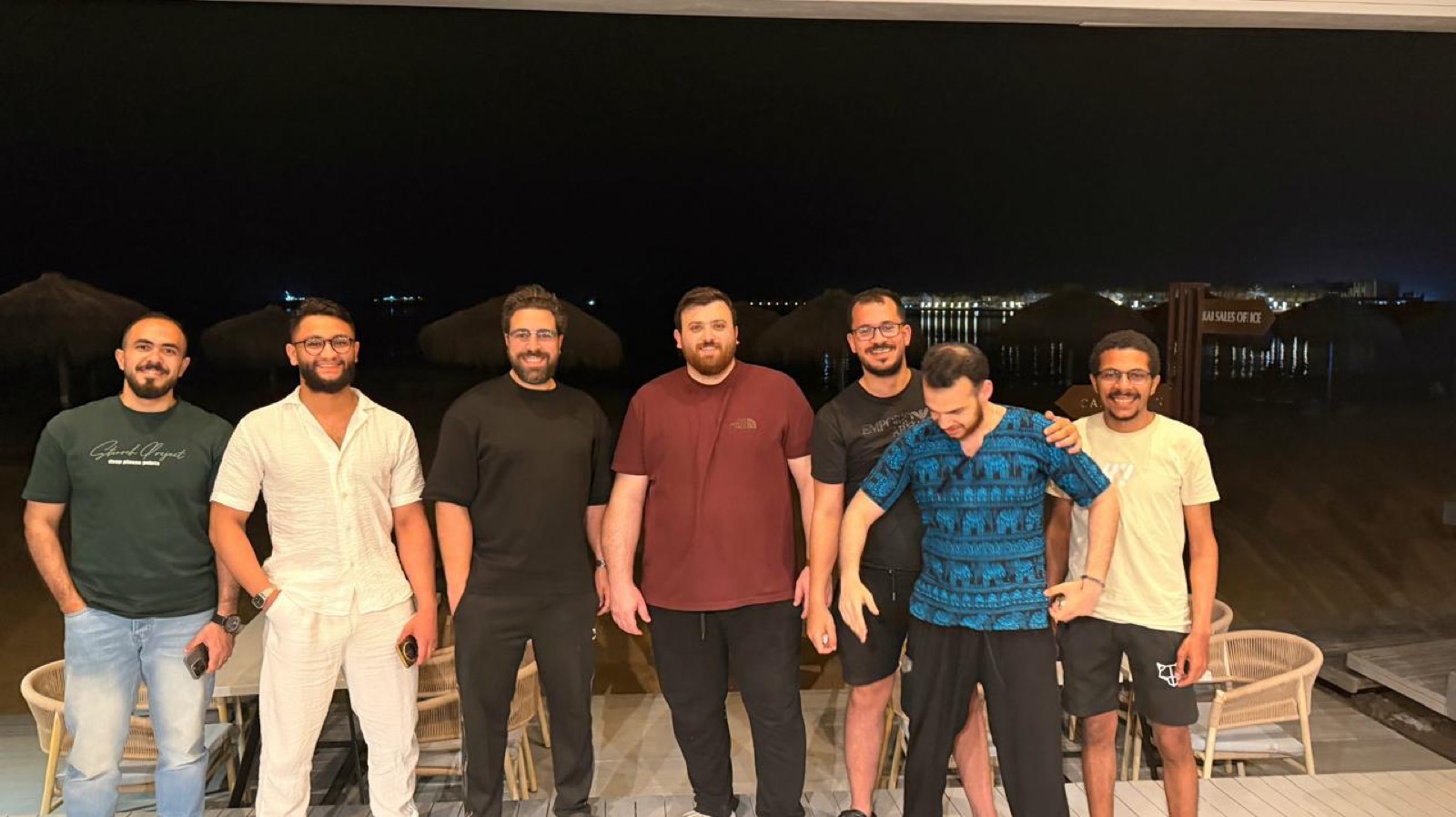 Epsilon AI team together by the sea at night